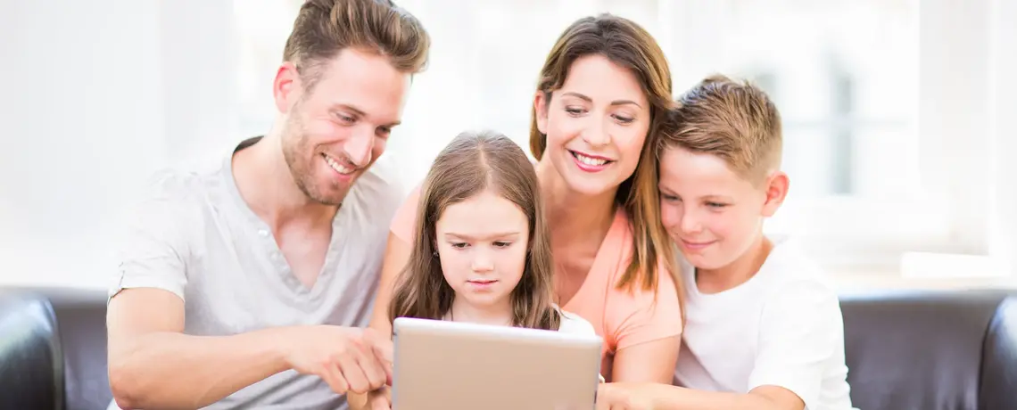 Eine Familie liest gemeinsam auf einem Tablet die Wochenzeitung